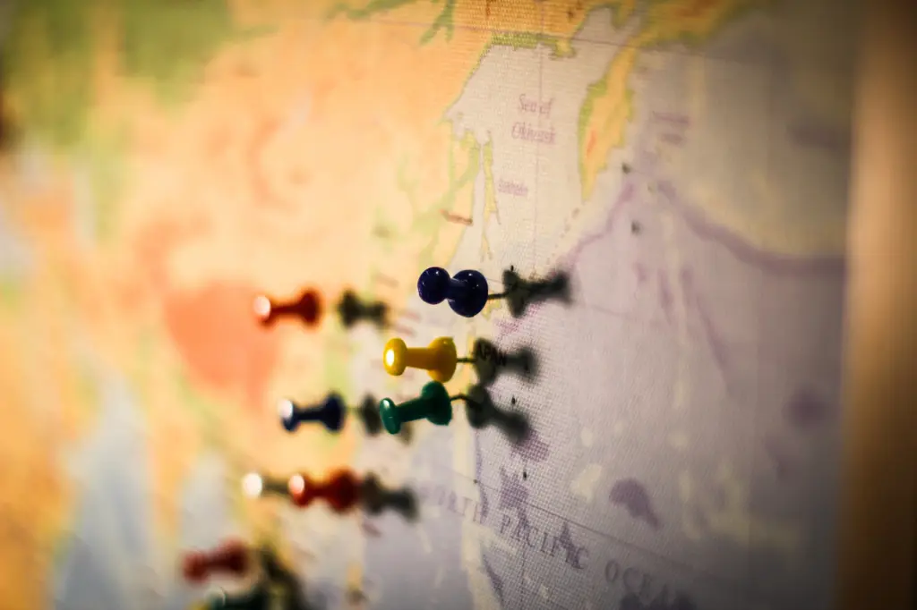 Picture of pins on a board of the world map
